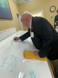 Selectman John Connolly adds his autograph to the Autograph Board
